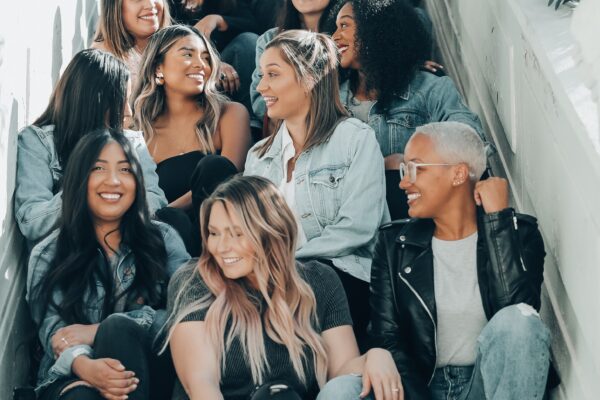 Group of Diverse women with smiling faces sitting in a stairwell